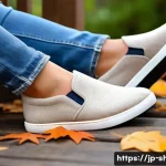 탐스 알파카 슬립온과 로퍼 리뷰 - A cozy autumn outdoor scene featuring a pair of beige alpaca wool slip-on shoes placed on wooden ste...