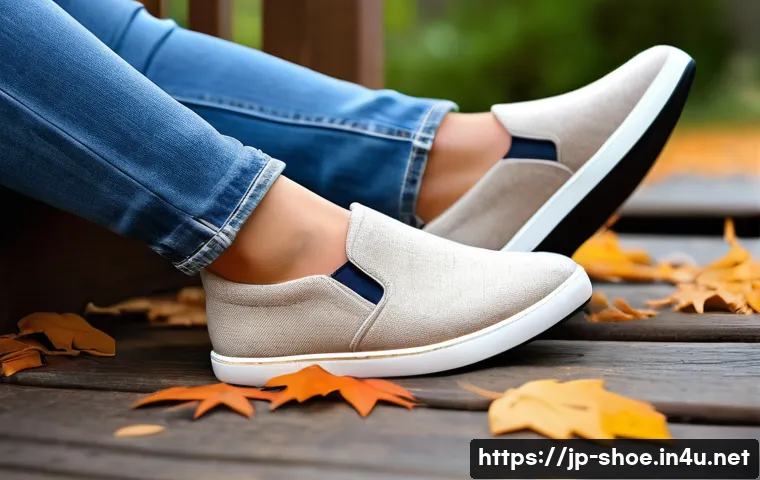 탐스 알파카 슬립온과 로퍼 리뷰 - A cozy autumn outdoor scene featuring a pair of beige alpaca wool slip-on shoes placed on wooden ste...